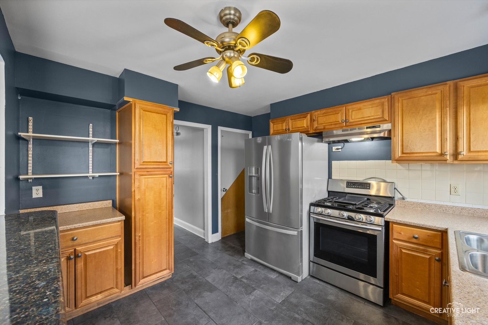 8044 West Lyons Street, Unit B Niles, IL 60714 - Photo 6 of 17 a kitchen with stainless steel appliances a stove a refrigerator and cabinets