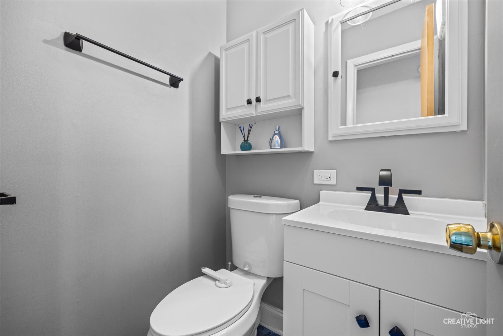 8044 West Lyons Street, Unit B Niles, IL 60714 - Photo 8 of 17 a bathroom with a toilet sink vanity and mirror