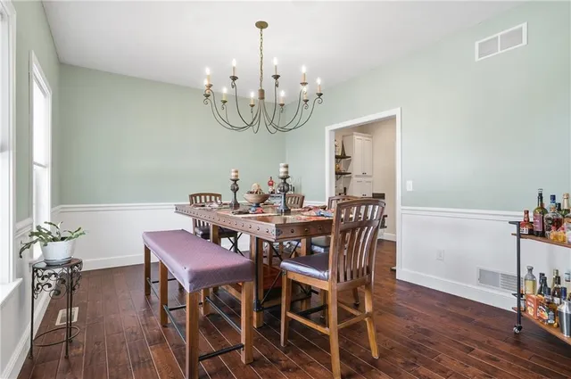 a view of a dining room with furniture wooden floor and chandelier
