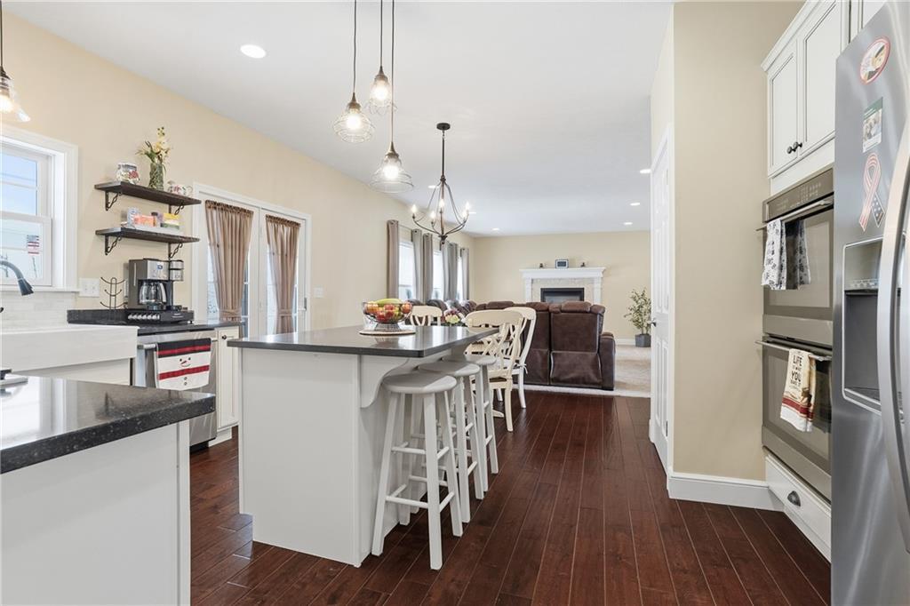 100 Mary Street Monaca, PA 15061 - Photo 18 of 49 a kitchen with stainless steel appliances kitchen island granite countertop a table chairs and a refrigerator