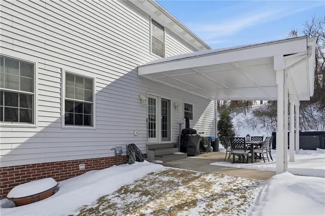a view of a patio with a dining table and chairs
