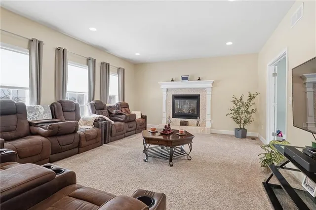 a living room with furniture a fireplace and a flat screen tv