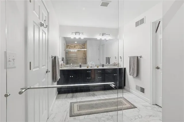a bathroom with a sink vanity and a mirror