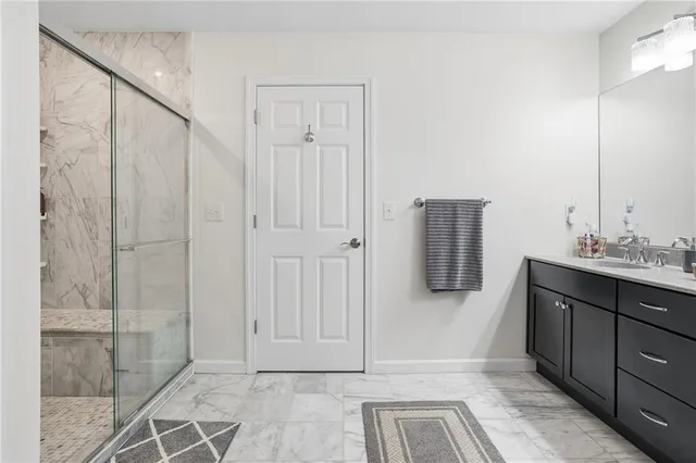 a bathroom with a sink and shower