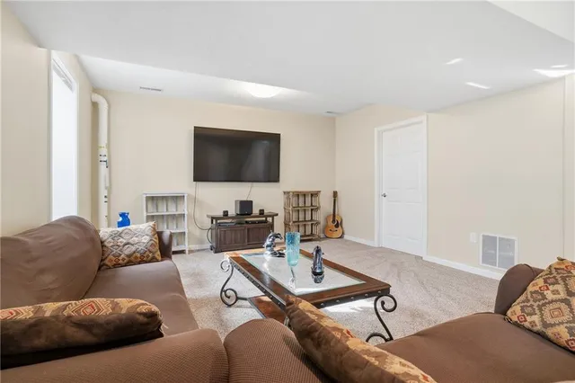 a living room with furniture a couch and a chandelier