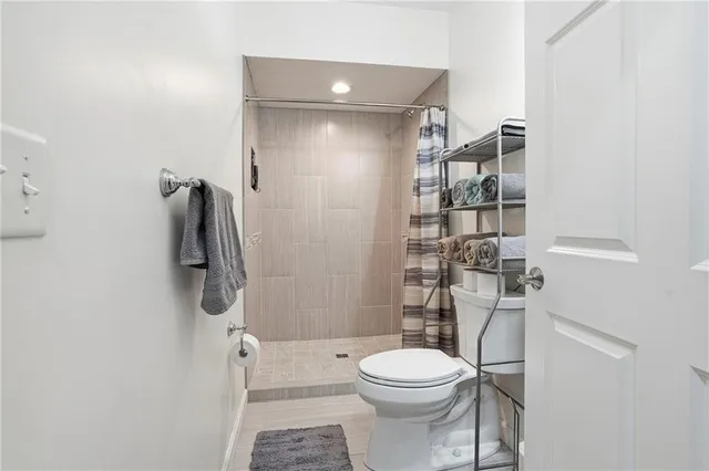 a bathroom with a toilet and a shower