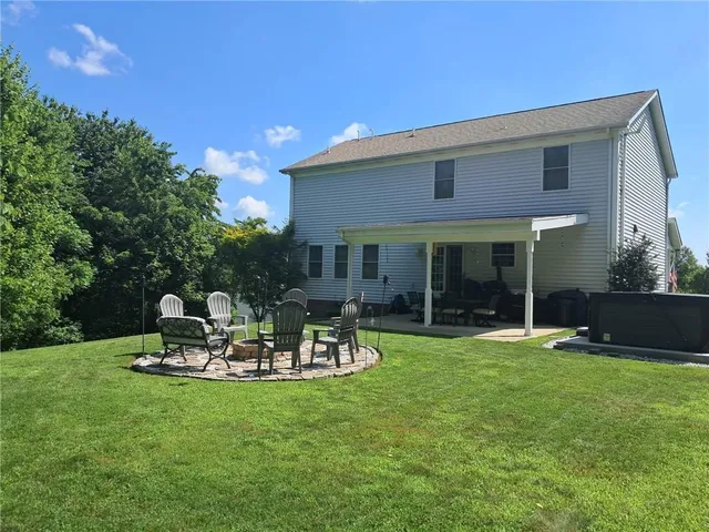 a view of a backyard with sitting area