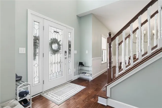 a view of an entryway with wooden floor and windows