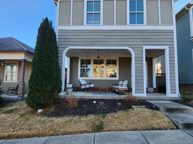 front view of a brick house with a yard