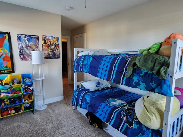 a bathroom with a granite countertop sink and toilet
