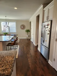a kitchen with stainless steel appliances granite countertop a refrigerator and a stove top oven