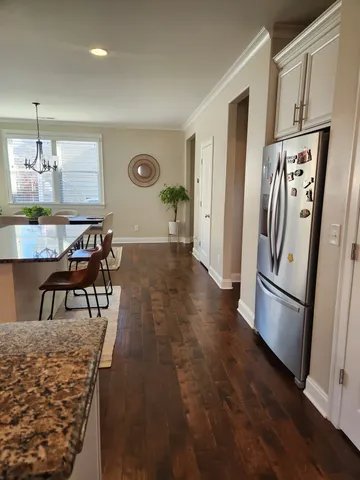 a kitchen with stainless steel appliances granite countertop a refrigerator and a stove top oven