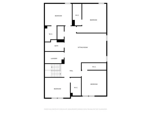 an empty room with wooden floor and window