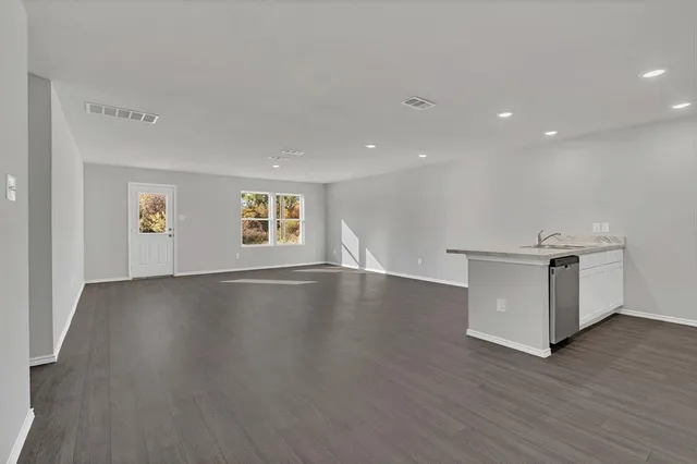 a kitchen with granite countertop a sink and a stove top oven