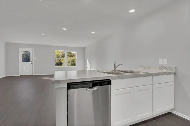 a kitchen with kitchen island a stove a sink and a refrigerator