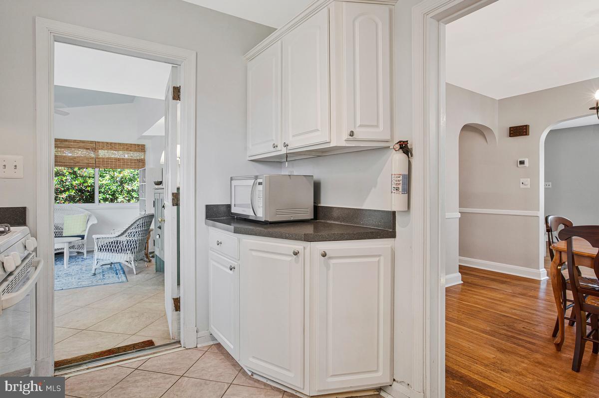 601 Forest View Road Linthicum Heights, MD 21090 - Photo 14 of 37 a kitchen with stainless steel appliances white cabinets and wooden floor