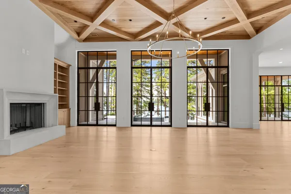 a large kitchen with kitchen island a large window a sink and stainless steel appliances