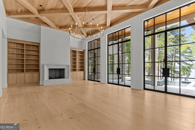 a view of a kitchen with white cabinets and a window