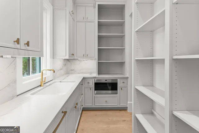 a kitchen with granite countertop a sink and a window