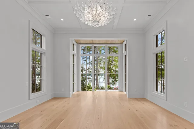 an aerial view of a house with a yard and lake view
