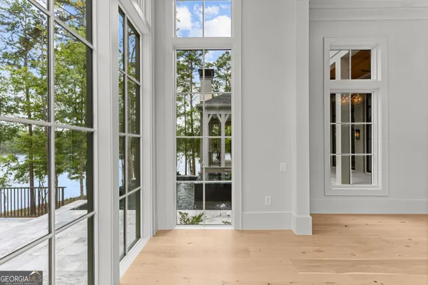 an aerial view of residential house with outdoor space and trees all around