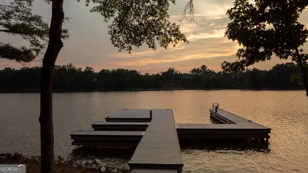 a view of a livingroom with a fireplace a ceiling fan and window