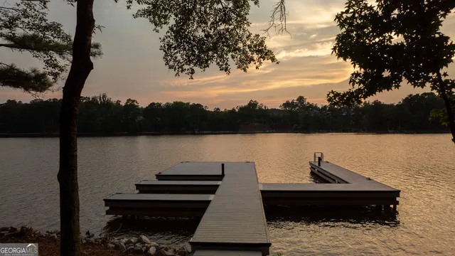 a view of a livingroom with a fireplace a ceiling fan and window