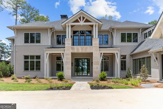 a kitchen with kitchen island a stove a sink a refrigerator and chairs
