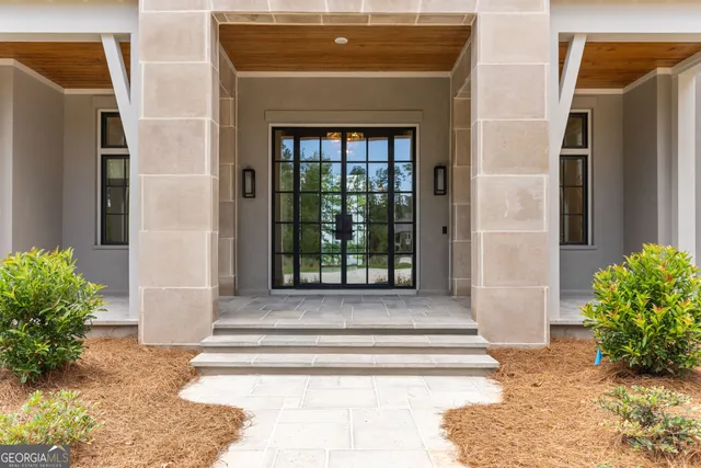 a large kitchen with stainless steel appliances kitchen island granite countertop a refrigerator and a stove top oven