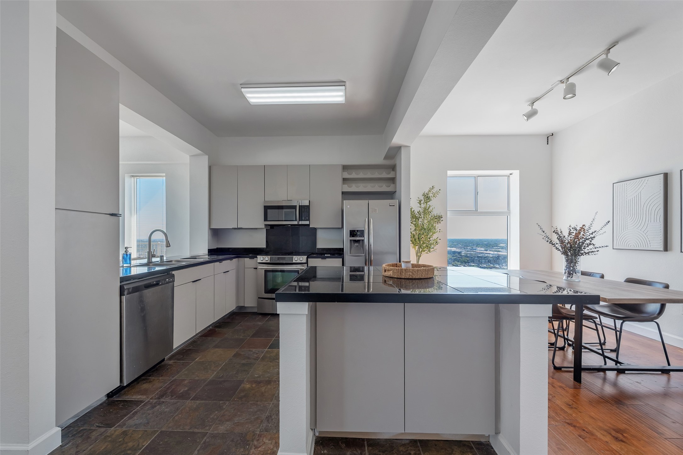 3505 Sage Road, Unit 2210 Houston, TX 77056 - Photo 11 of 40 A fresh perspective reveals the seamless connection between the open kitchen and dining area, bathed in natural light and defined by an airy, elegant flow.