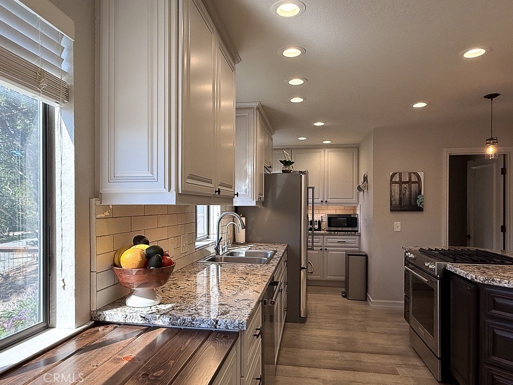 2298 Tipton Street Cambria, CA 93428 - Photo 11 of 54 a kitchen with granite countertop a sink stainless steel appliances and cabinets