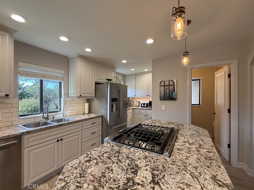 2298 Tipton Street Cambria, CA 93428 - Photo 12 of 54 a kitchen with stainless steel appliances kitchen island granite countertop a sink stove and refrigerator