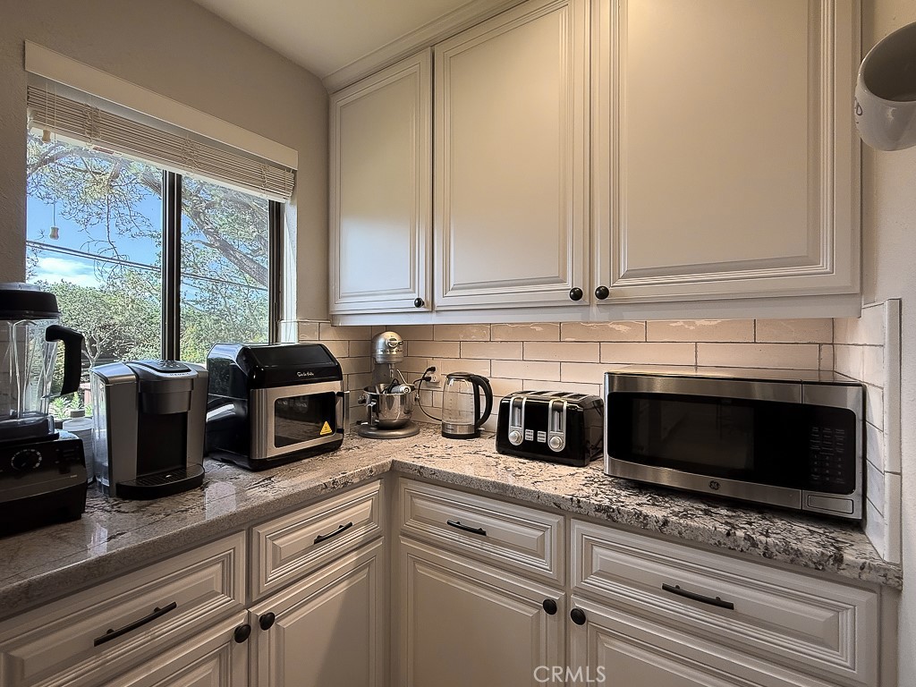 2298 Tipton Street Cambria, CA 93428 - Photo 16 of 54 a kitchen with a microwave and cabinets