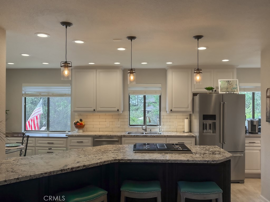 2298 Tipton Street Cambria, CA 93428 - Photo 18 of 54 a kitchen with stainless steel appliances granite countertop a sink stove and refrigerator