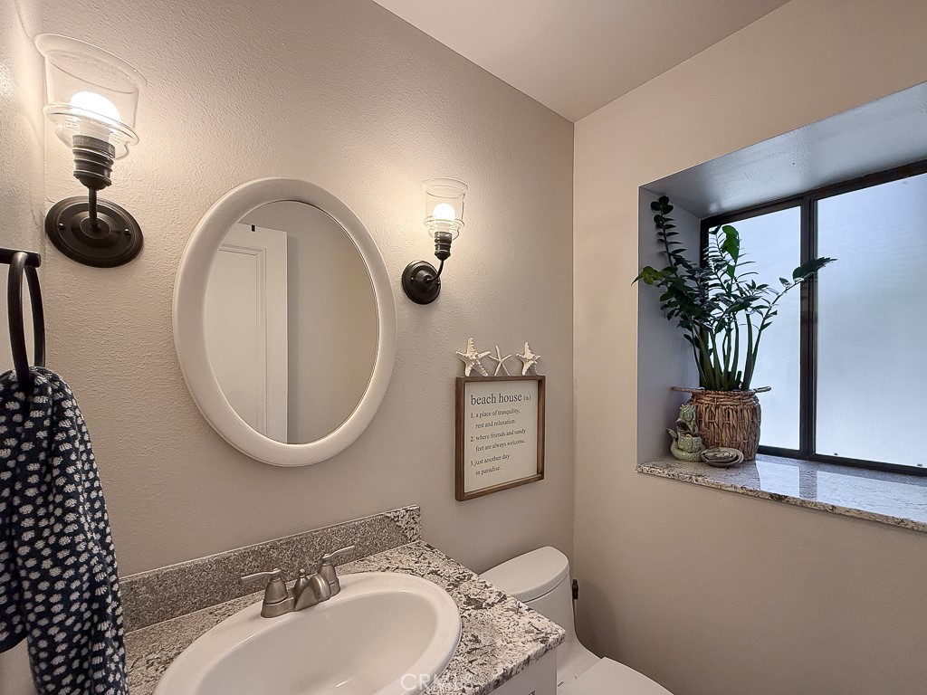 2298 Tipton Street Cambria, CA 93428 - Photo 23 of 54 a bathroom with a toilet a sink and mirror