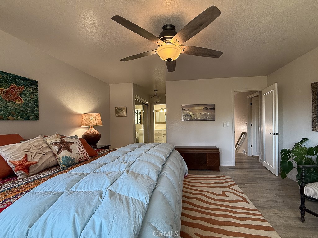 2298 Tipton Street Cambria, CA 93428 - Photo 26 of 54 a bedroom with double bed and a chandelier