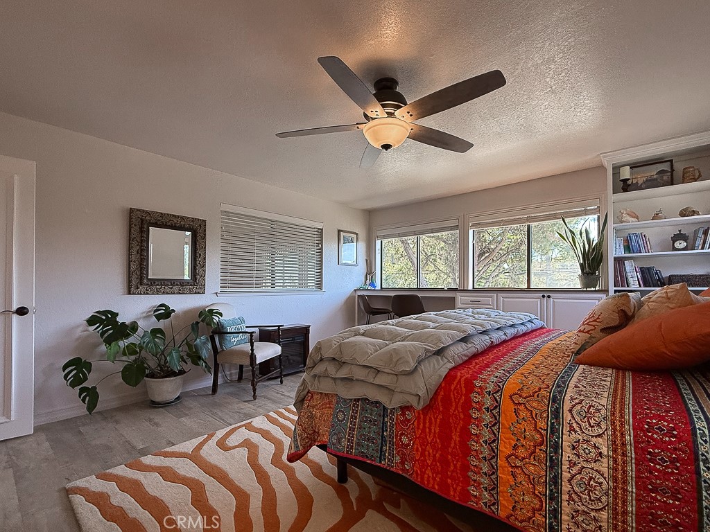 2298 Tipton Street Cambria, CA 93428 - Photo 28 of 54 a spacious bedroom with a bed and a chandelier
