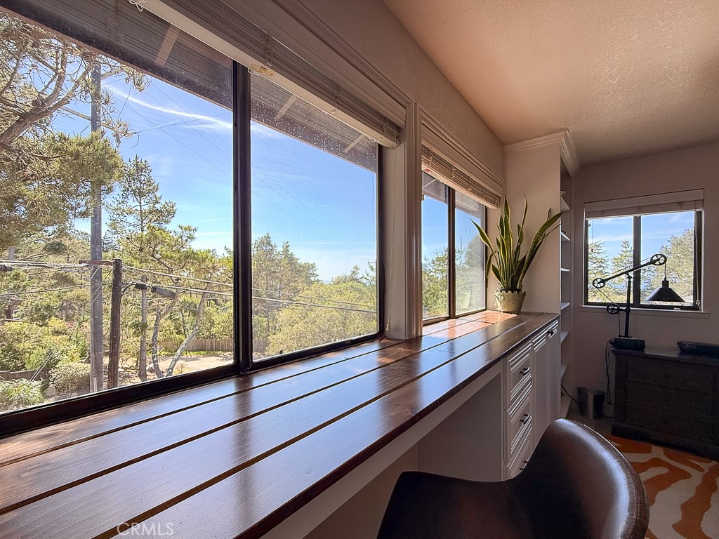 2298 Tipton Street Cambria, CA 93428 - Photo 30 of 54 Built-ins with a shelf above create a perfect desk or workspace with beautiful wooded and a peekaboo ocean view!