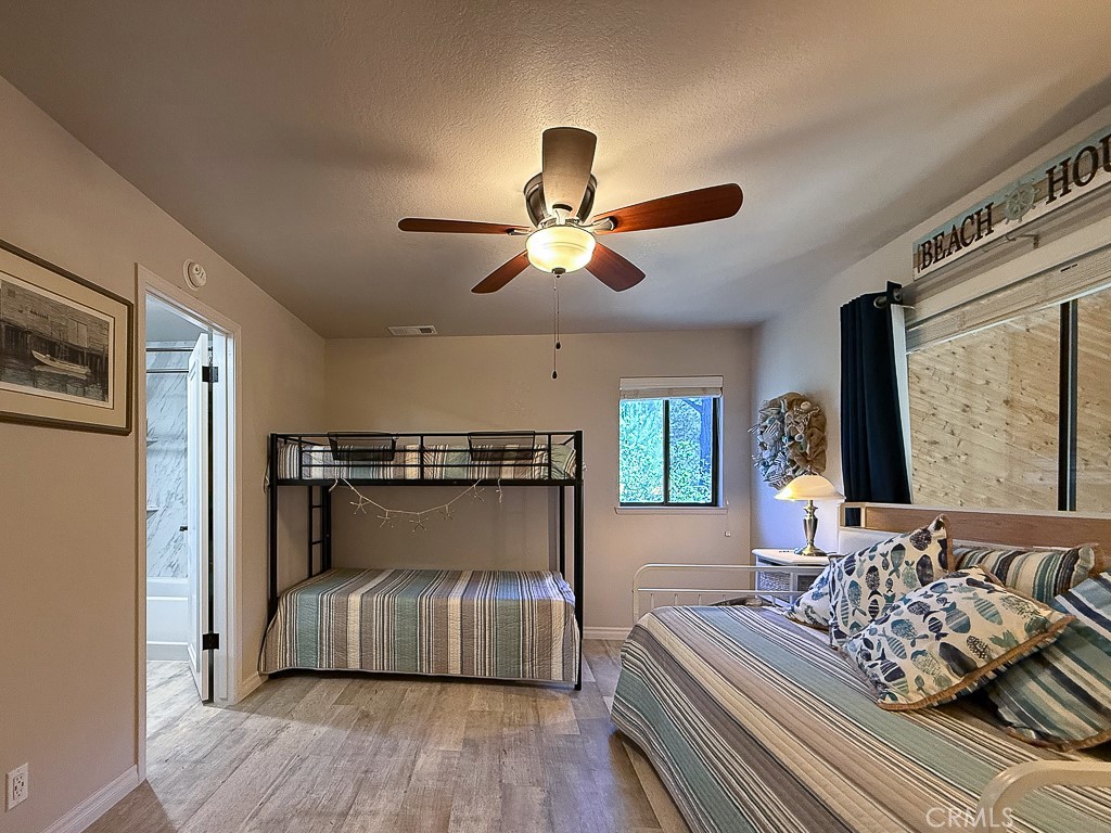 2298 Tipton Street Cambria, CA 93428 - Photo 35 of 54 a bedroom with bed and a chandelier