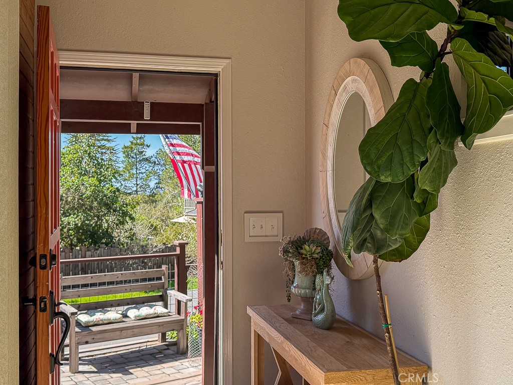 2298 Tipton Street Cambria, CA 93428 - Photo 39 of 54 a room with a floor to ceiling window and a potted plant