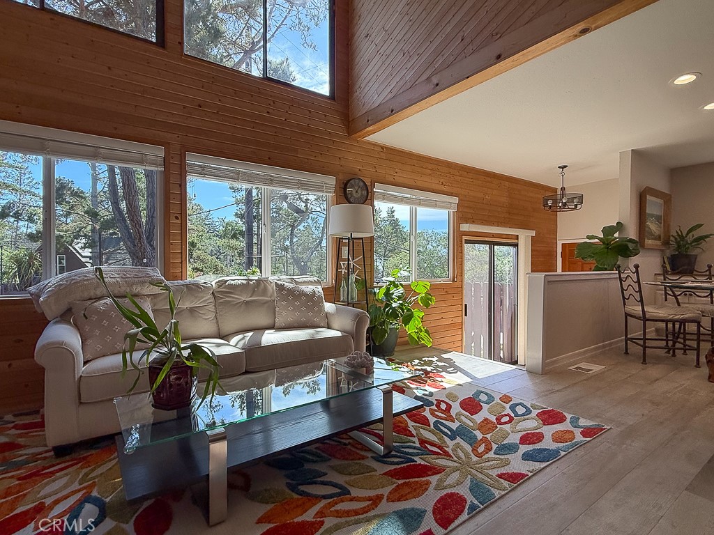 2298 Tipton Street Cambria, CA 93428 - Photo 5 of 54 a living room with furniture fireplace and a floor to ceiling window