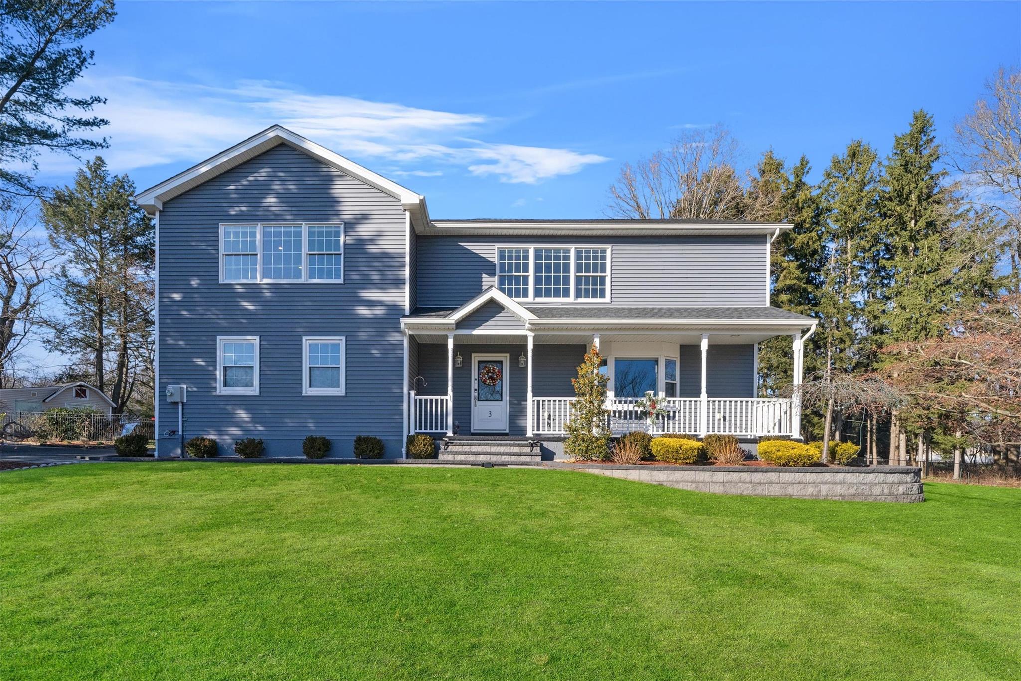 a front view of a house with a yard table and chairs