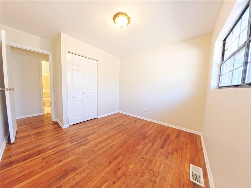 3881 Pin Oak Circle Atlanta, GA 30340 - Photo 12 of 26 a view of empty room with wooden floor and fan