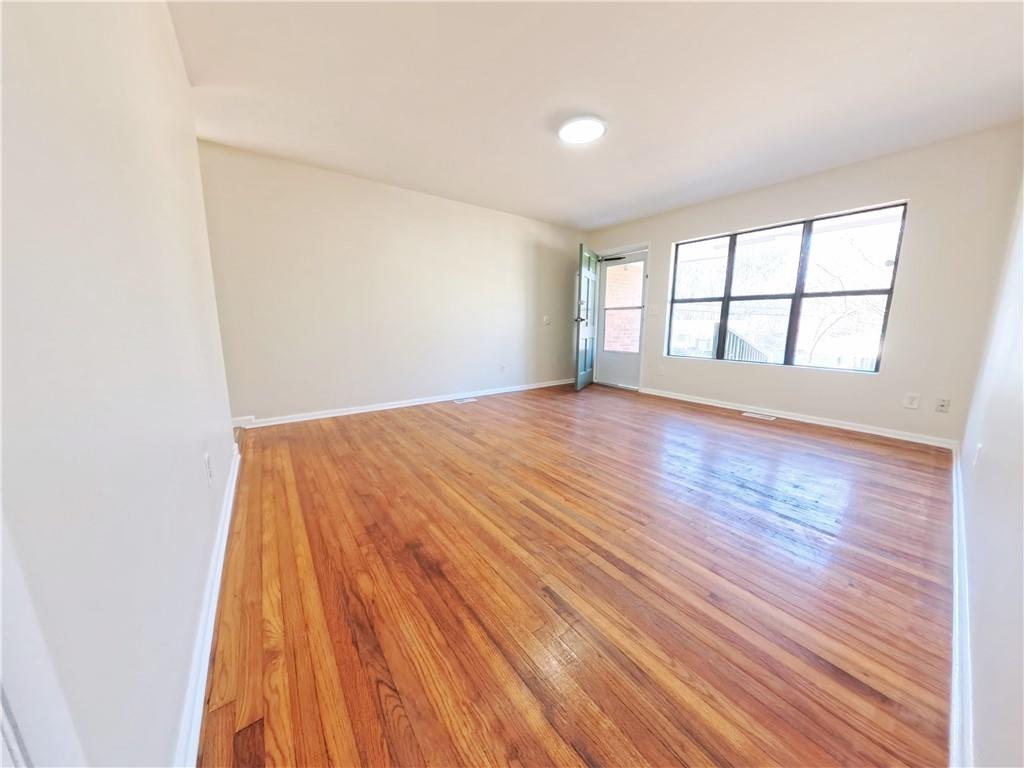 3881 Pin Oak Circle Atlanta, GA 30340 - Photo 16 of 26 an empty room with wooden floor and windows