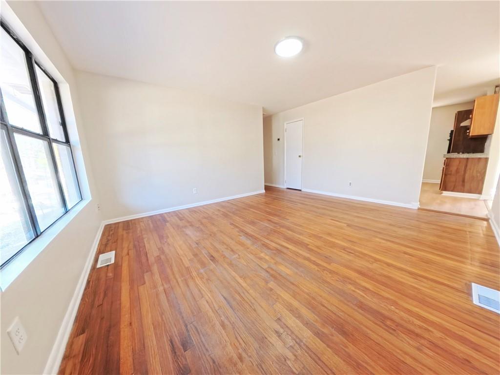 3881 Pin Oak Circle Atlanta, GA 30340 - Photo 17 of 26 a view of empty room with wooden floor and fan