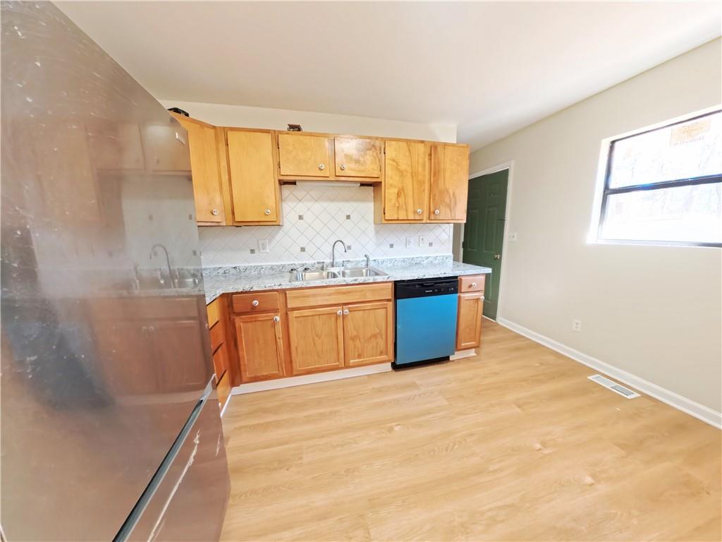 3881 Pin Oak Circle Atlanta, GA 30340 - Photo 18 of 26 a kitchen with stainless steel appliances granite countertop a sink stove and cabinets