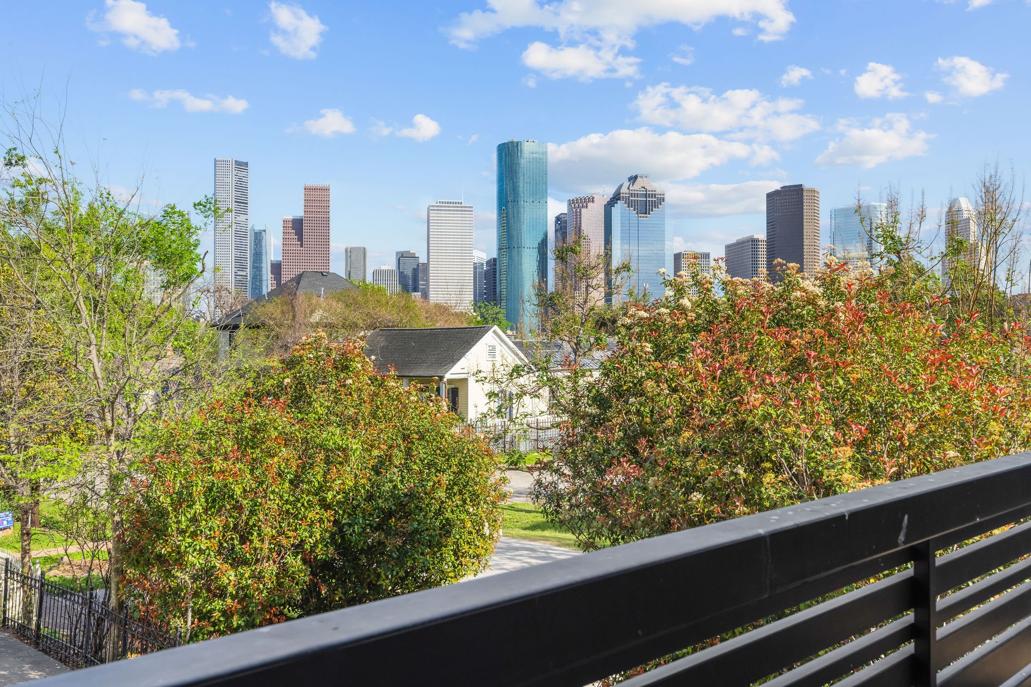 908 White Street Houston, TX 77007 - Photo 2 of 21 View of the downtown Houston area from the balcony, offering a unique city backdrop.