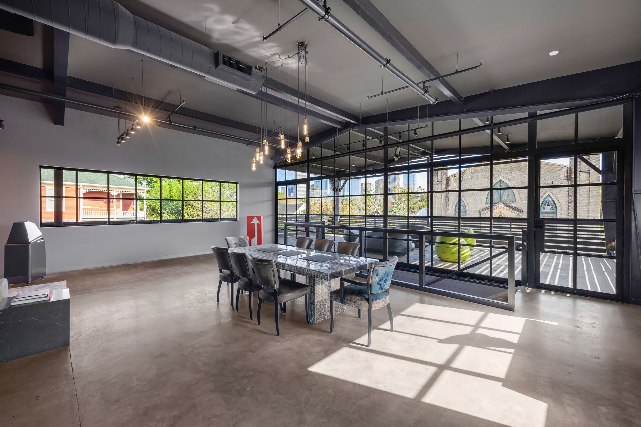 908 White Street Houston, TX 77007 - Photo 5 of 21 Another angle of main living space highlighting large windows, natural light, and direct connection to the outdoor terrace.