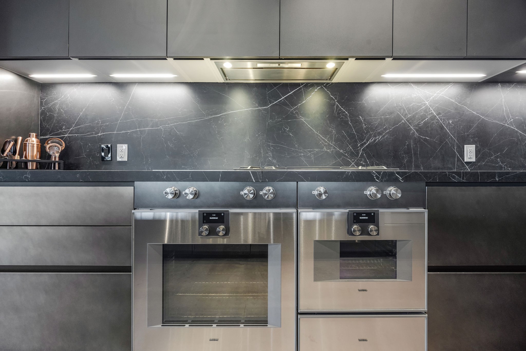 908 White Street Houston, TX 77007 - Photo 10 of 21 Kitchen featuring all Gaggenau appliances, including double ovens, gas range, and sleek modern finishes.
