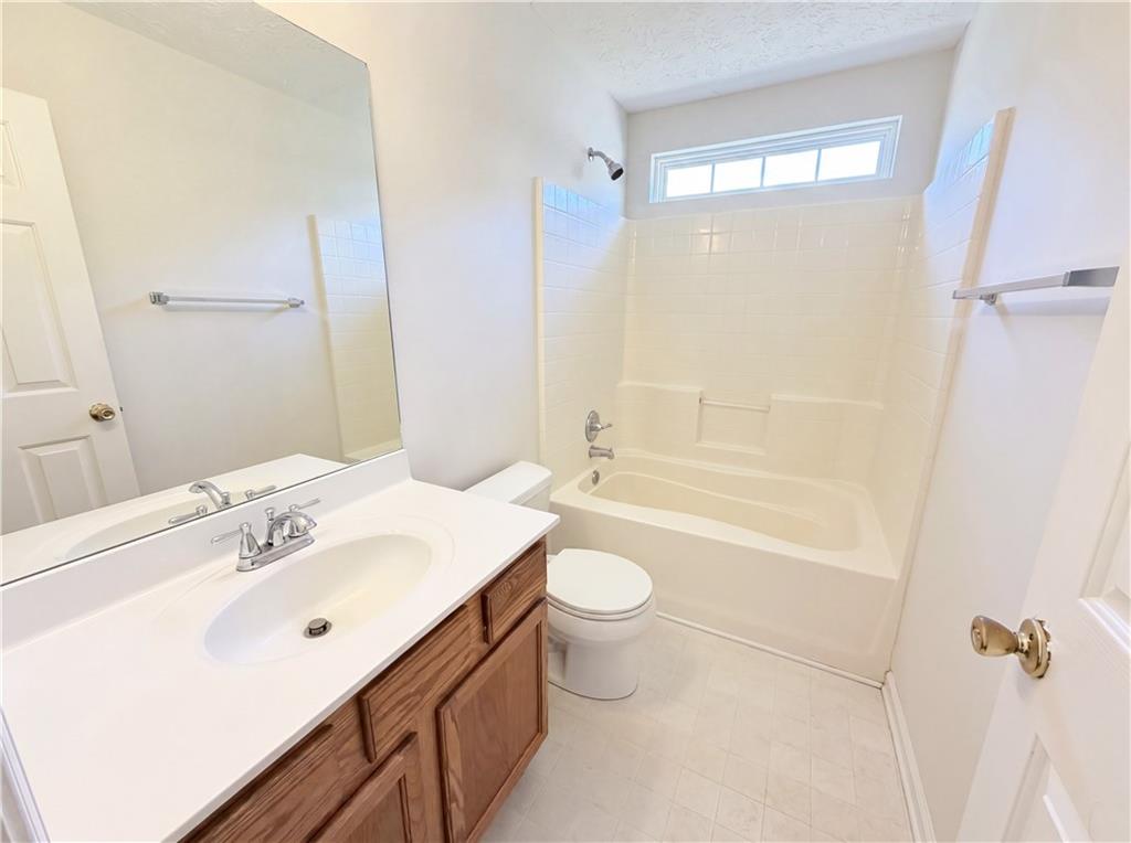 503 Oakleaf Court Acworth, GA 30102 - Photo 12 of 17 a bathroom with a sink a toilet and shower